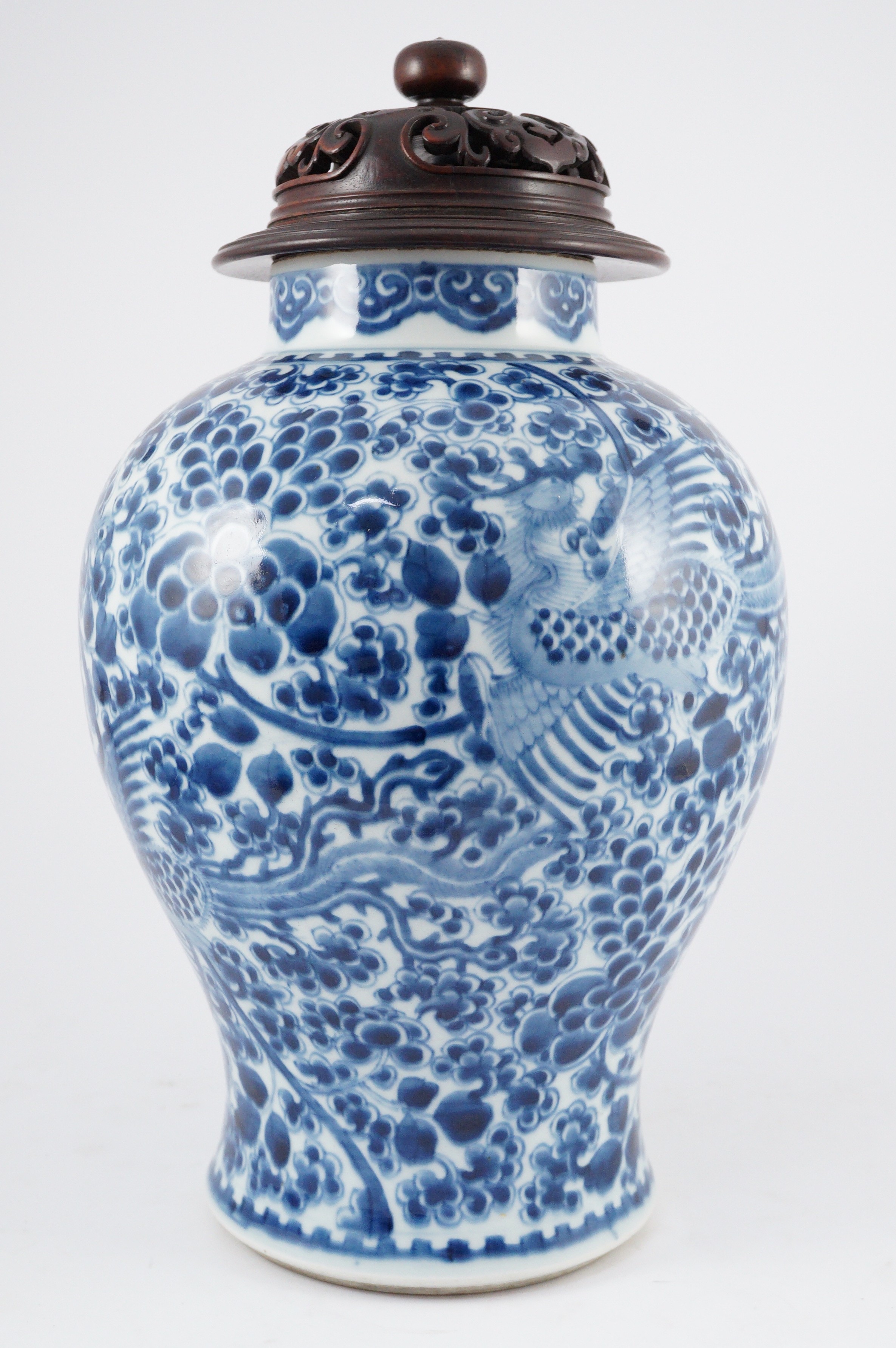 A Chinese blue and white ‘phoenix and peony’ baluster jar, Kangxi period, with a later wood cover, 36cm high excluding later wood cover